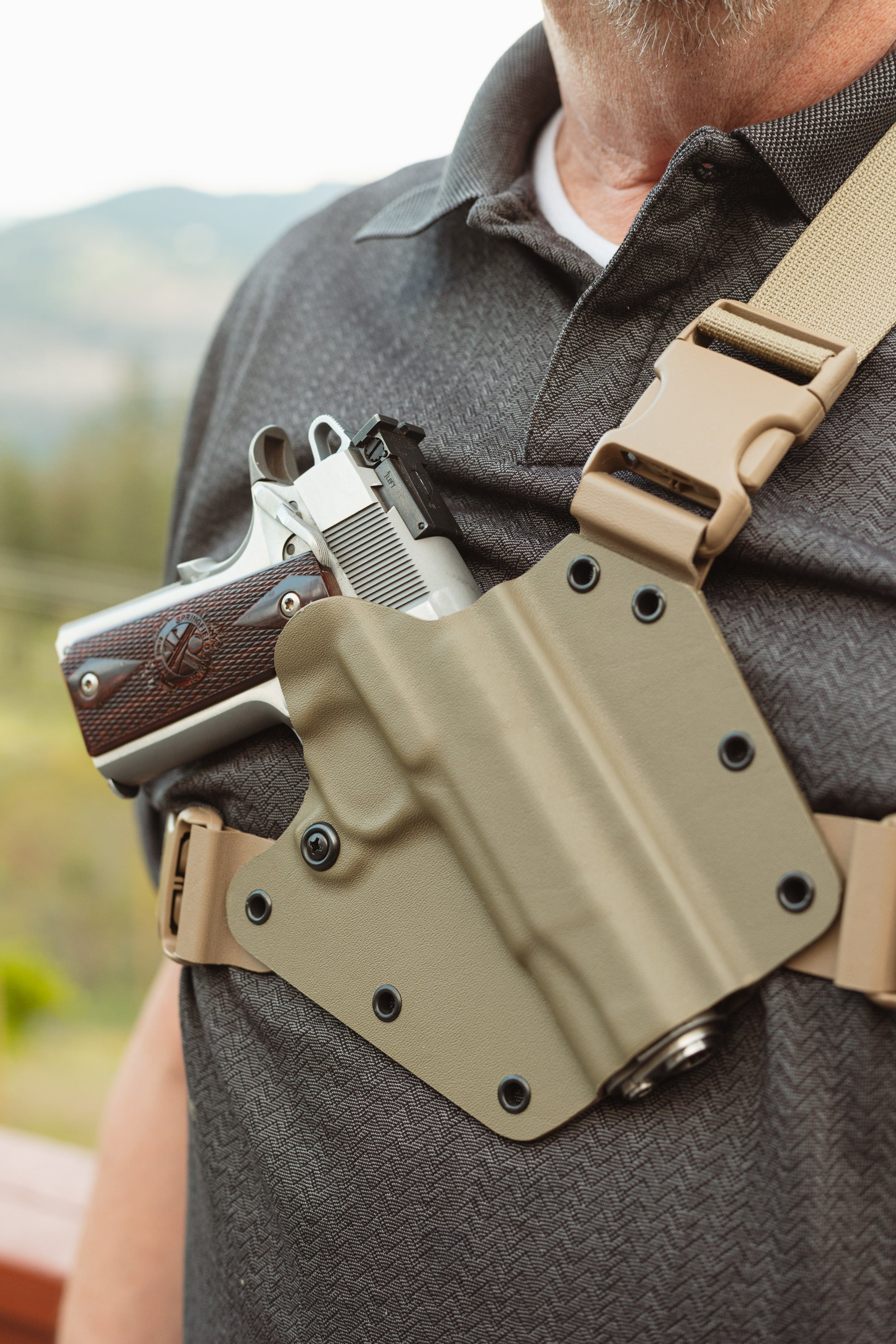 Arctos Arms chest harness holster made for a Springfield 1911 pistol. Made with FDE kydex with FDE harness.